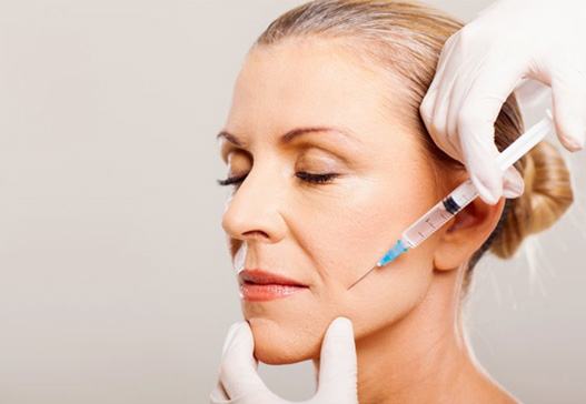 a woman receiving BOTOX injections for cosmetic treatment