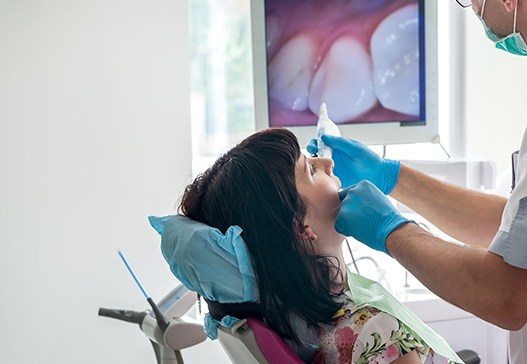 Dentist examining patient during dental checkup and teeth cleaning visit