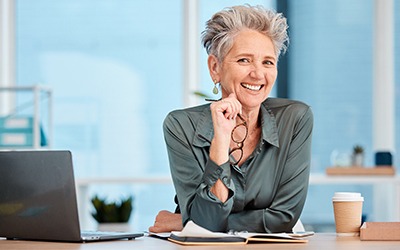 Woman smiling at a desk