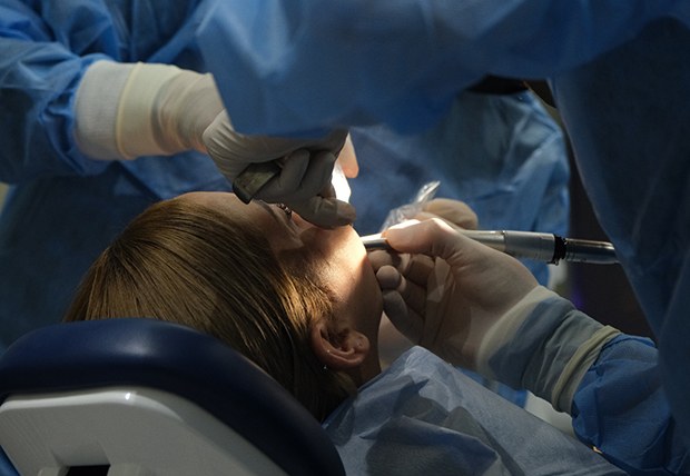 Woman getting dental implant surgery