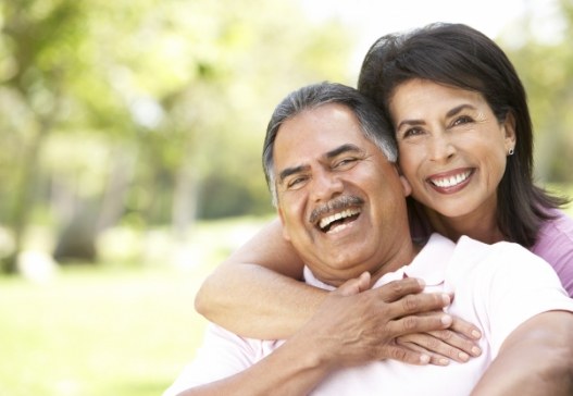 Man and woman enjoying the benefits of dental implants