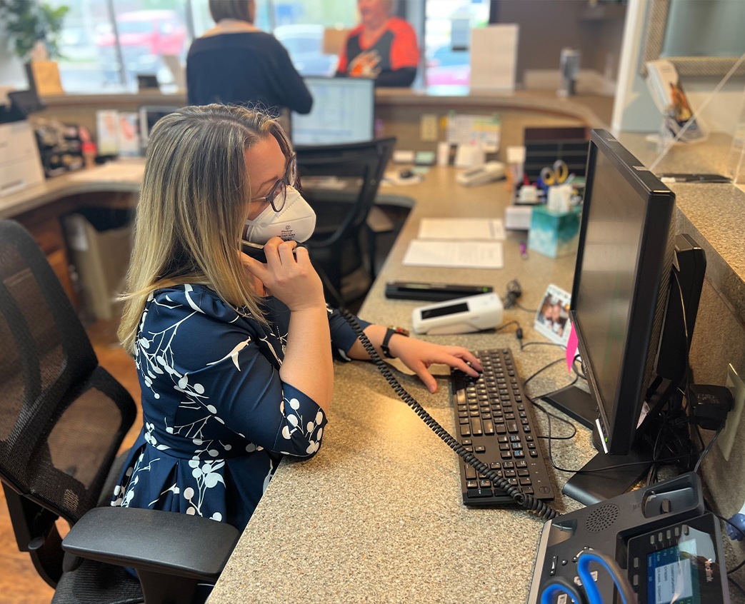 Warsaw dental team member answering the phone at front desk