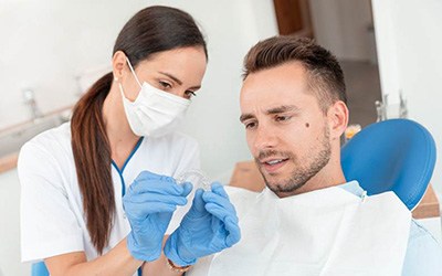 Man at the dentist for Invisalign in Warsaw