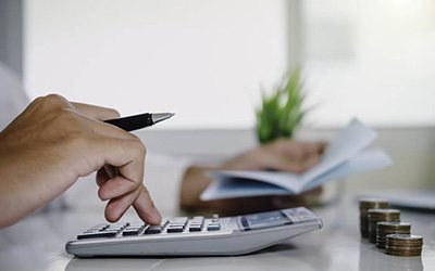 Man calculating the cost of Invisalign in Warsaw