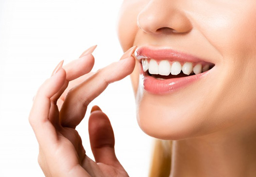 Close up of patient lightly touching her gums