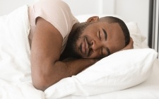 Man sleeping soundly thanks to sleep apnea therapy