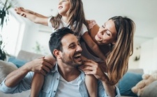 Family smiling after orthodontic treatment consultation