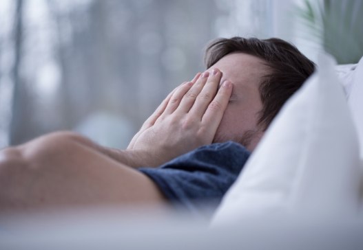 Frustrated person in need of sleep apnea treatment