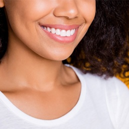 : A smiling woman showing off her dental veneers from Warsaw