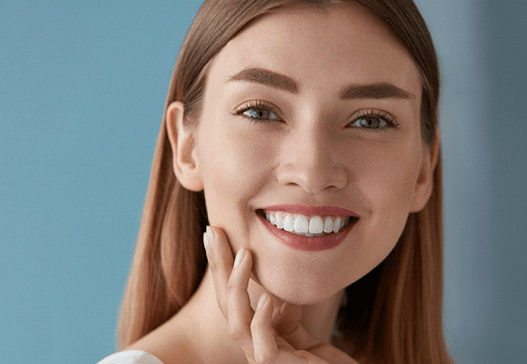 a woman smiling after teeth whitening in Warsaw