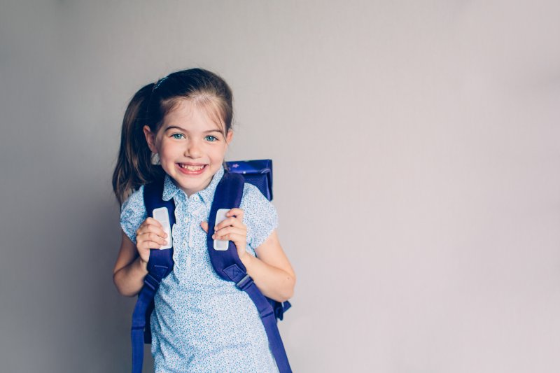 child smiling after visiting their dentist in Warsaw