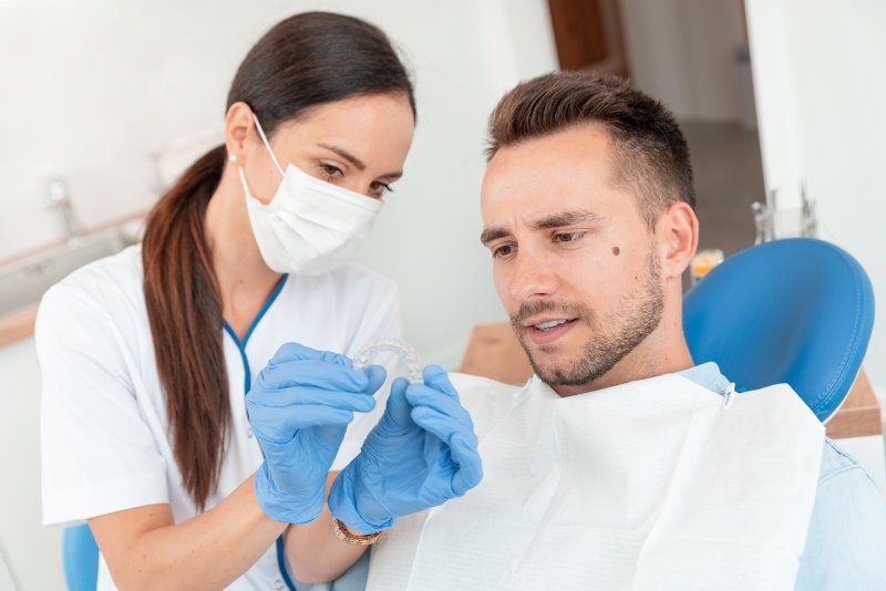 Man at dentist getting Invisalign in Warsaw