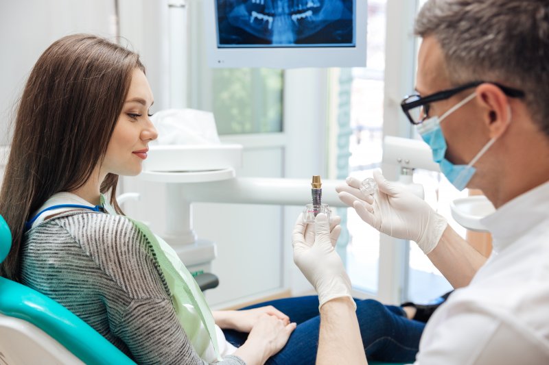 A dentist explaining dental implant success