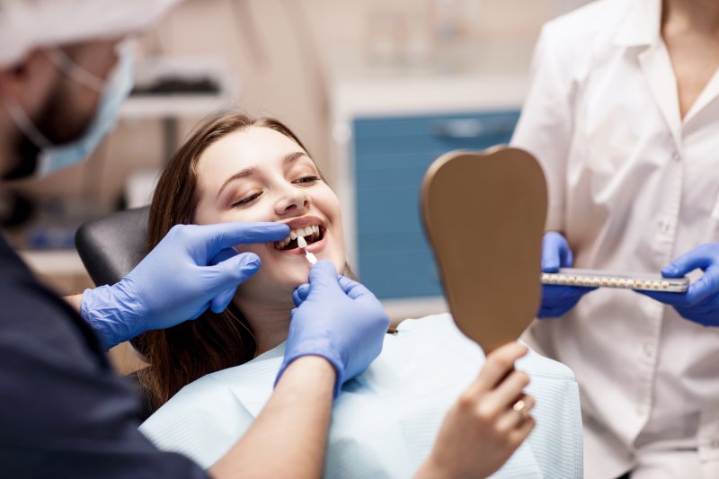 A woman receiving cosmetic dentistry from a dentist