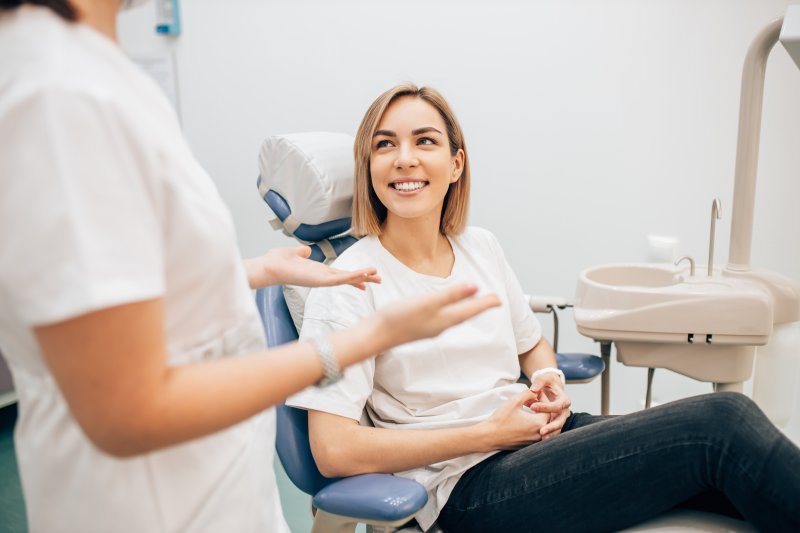 A woman talking with her dentist about her oral health
