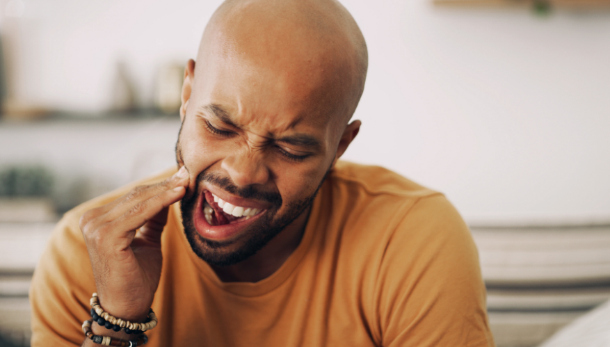 Man holding jaw in pain
